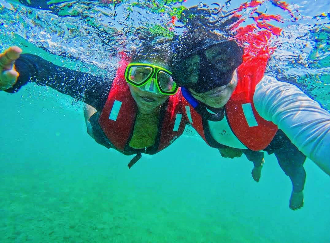 Two guests snorkeling with masks and life jackets at Pigeon Island National Park, Nilaveli, Sri Lanka